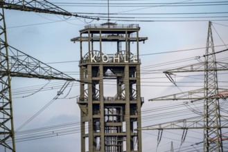 Headframe of the former, disused Walsum colliery, electricity pylons of the STEAG coal-fired power