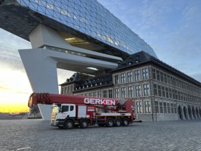 Building cleaners cleaning window panes, cleaning a facade, lorry working platform of the German