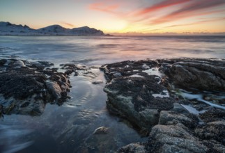 Sunset in winter at Skagsanden, rock formations on the beach at Flakstad, Flakstadøy, Lofoten,