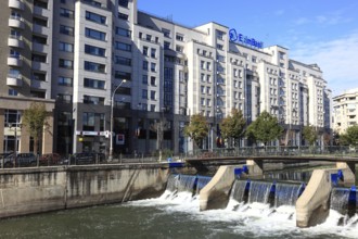 Apartment blocks and office buildings, bank building on the Dambovita River, Bucharest, Romania,