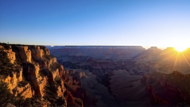 Sunrise over grand canyon in vibrant colors casting light on overhanging rock formations, AI