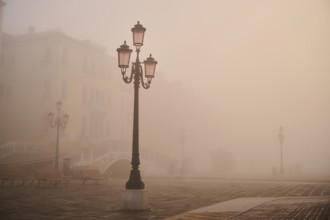 Lanterns at 'Alilaguna' before sunrise in Venice on a foggy morning in winter, Italy, Europe