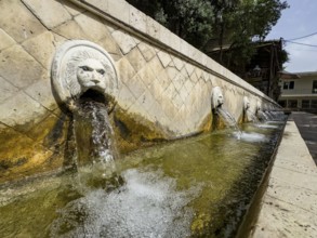 Partial view of lion fountain Venetian fountain Kefalovrisi on the main square of Spili village,