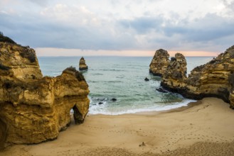 Rocky coast with beach and red rocks, Praia do Camilo, Lagos, Algarve, Portugal, Europe