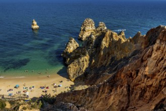 Rocky coast with beach and red rocks, Praia do Camilo, Lagos, Algarve, Portugal, Europe