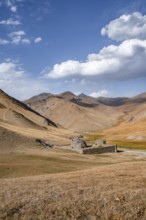 Historic caravanserai Tash Rabat from the 15th century, with yellow hills, Atbashy district in the