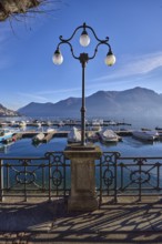 Lantern, forged railing, lakeside promenade, shadow, marina, tree, motorboats, haze, mountain,