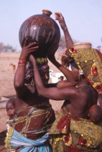 Life in the Sahel region of northern Nigeria, west Africa, early 1980s - women carrying water