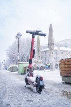 E-scooter standing in the snow in an urban environment, Sindelfingen, Germany, Europe