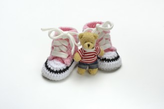 Pink baby shoes with teddy bear