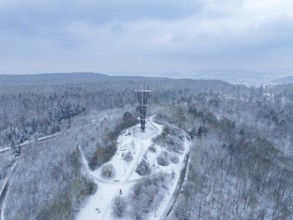 Snow-covered paths lead to a tower in a wintry wooded area, cool atmosphere, Schönbuchturm,