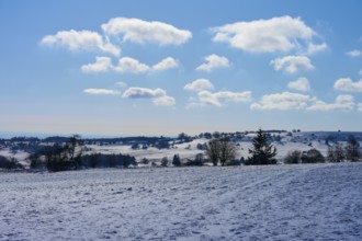 Bright winter landscape with clouds and a clear blue sky over snow-covered fields, Winter,