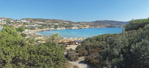 Mega Amoopi beach with parasols and surrounding vegetation, Ammopi, Lakki, Karpathos, Greece,