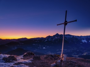 Rauher Kopf summit cross at dawn, behind Dachstein, Tennengebirge and Hoher Göll, Bischofswiesen,