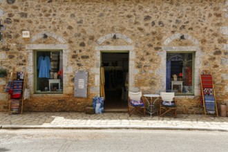 Façade with souvenir shop, typical stone house in Stoupa, former fishing village, Mani, Greece,