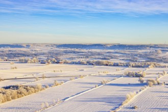 Aerial view at a rural landscape with snow and frost on the fields a cold winter day, Sweden,