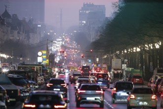 Busy Kaiserdamm and Bismarckstraße during morning rush hour in foggy and cloudy winter weather,