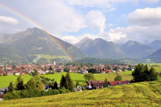 View over Oberstdorf with rainbow and Allgäu Alps, Oberallgäu, Bavaria, Germany, Europe