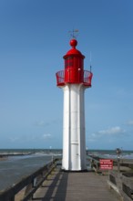 Close-up of a red lighthouse with blue sky and sea, Trouville-sur-Mer, Trouville, river Touques,