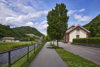 River Kinzig, metal railing, footpath and cycle path, trees, historic railway station building,