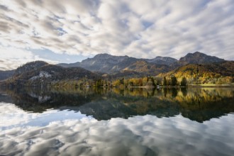 Autumnal mountain landscape with mountain peaks Herzogstand and Heimgarten, reflection in Lake