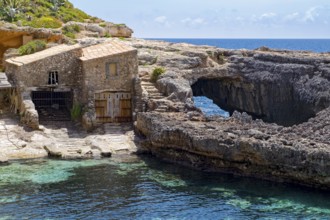 Fishing huts in the Cala de s'Almonia, Cap de ses Salines nature reserve, Cala Llombards, Majorca,