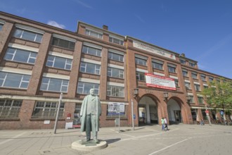 Adam Opel memorial, bronze statue in front of the old Opel main portal, Bahnhofsplatz, Rüsselsheim,