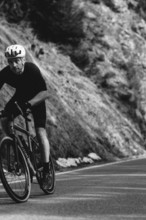 Road bike rider in spring in the Allgäu against the picturesque backdrop of the Alps, Bavaria,