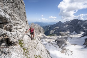 Mountaineer with helmet in a secured via ferrata, Zugspitz via ferrata, ascent to the Zugspitze,