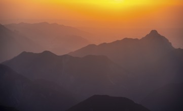 Silhouettes of mountains at sunset, view from the summit of the Zugspitze, Wetterstein Mountains,