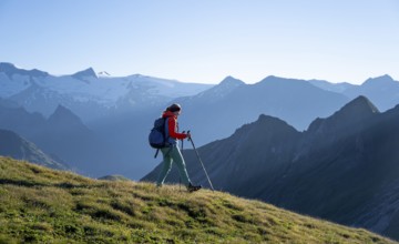 Hiker enjoying the mountain panorama in the morning, Venediger group, behind Dreiherrenkopf,