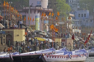 Holy city and colourful rowing boats on the Ganges river at Varanasi, Uttar Pradesh, India, Asia