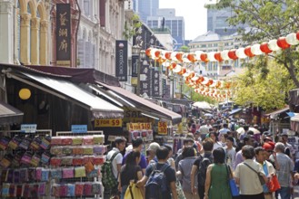 Pedestrians shopping in the colourful Chinatown neighbourhood in Singapore