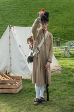 Reenactor in French Line Infantry uniform loading Napoleonic flintlock muzzle-loaded musket at the