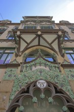 Oriel with decorations on historic commercial building, view upwards, detail, inscription, house