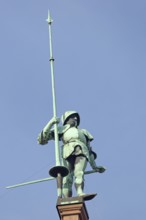 Sculpture knight with helmet, lance on roof, statue, figure, bronze, spear, armour, roof, spear,