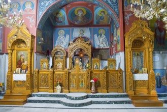 Ornamented Orthodox church altar with icons and golden wooden decoration, pilgrimage church of Agia