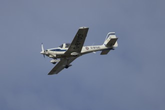 Grob G115E Tutor aircraft flying in a blue sky, England, United Kingdom, Europe