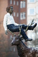 Sculpture by Stephan Balkenhol entitled Man with stag, painted bronze, surreal combination,