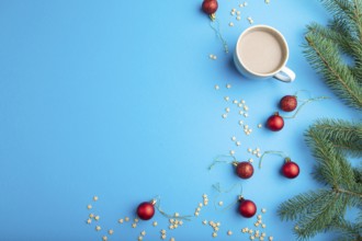 Christmas or New Year composition. Decorations, red balls, fir and spruce branches, cup of coffee,