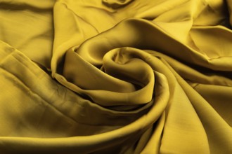 Fragment of yellow and green tissue. Side view, synthetic textile background and texture. wave