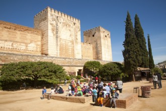 Fortified walls of the Alcazaba castle in the Alhambra complex, Granada, Spain with a group of