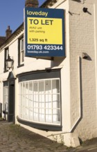 Loveday estate agent To Let sign commercial shop property, High Street, Marlborough, Wiltshire,