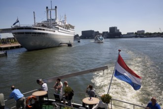 Spido tour boats view the SS Rotterdam former flagship of the Holland-America line now a hotel and