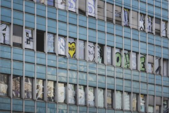 The logo of Berlin's public transport company BVG appears as graffiti on an empty office building