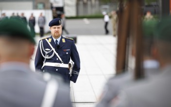 An air force soldier of the guard battalion gives commands to army soldiers of an honour formation