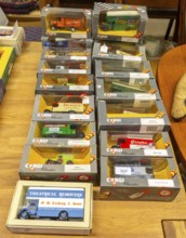 Boxes of Corgi model trucks, vans and other vehicles on display at auction, UK