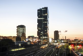 Sunset at the Modersohn Bridge, view of railway tracks, trains and the 140 metre high Amazon office