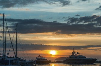 Sunset with cloud sky on the pier with yachts