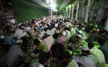 Muslim devotees have 'iftar' meal together to break their fast during the holy month of Ramadan, at